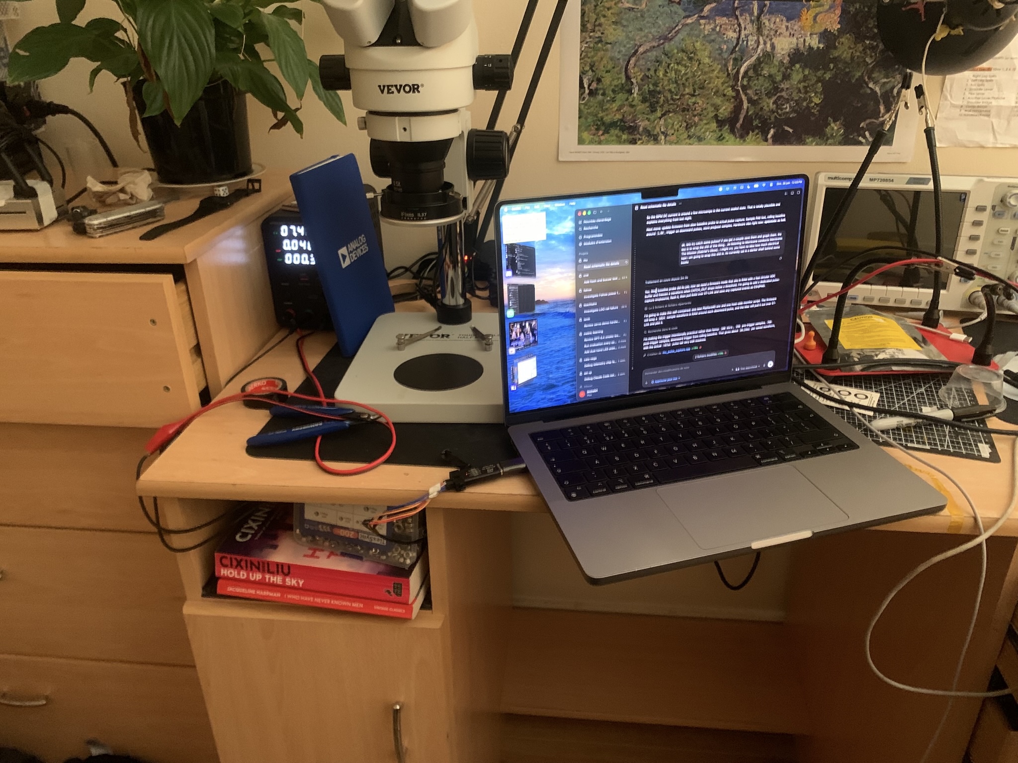 Mu's initial test setup on the desk beneath a microscope