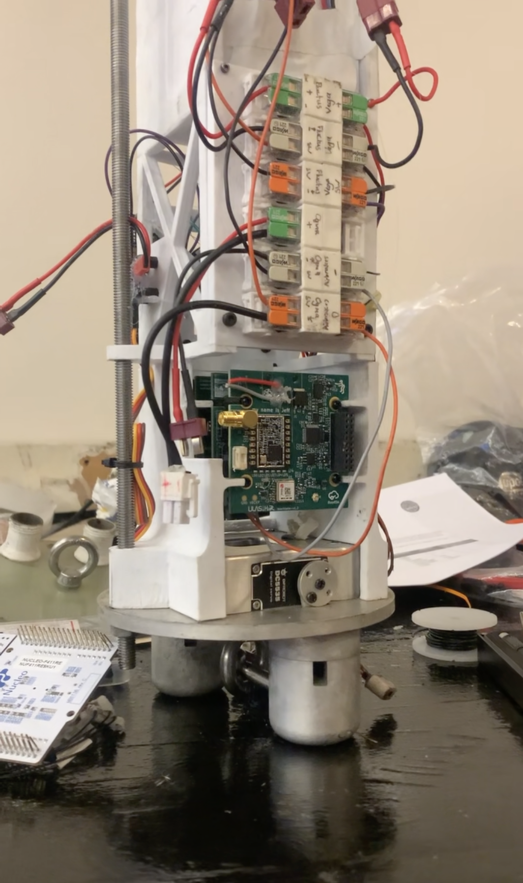Ogma Rev 1 mounted vertically in the rocket avionics bay beneath the terminal blocks