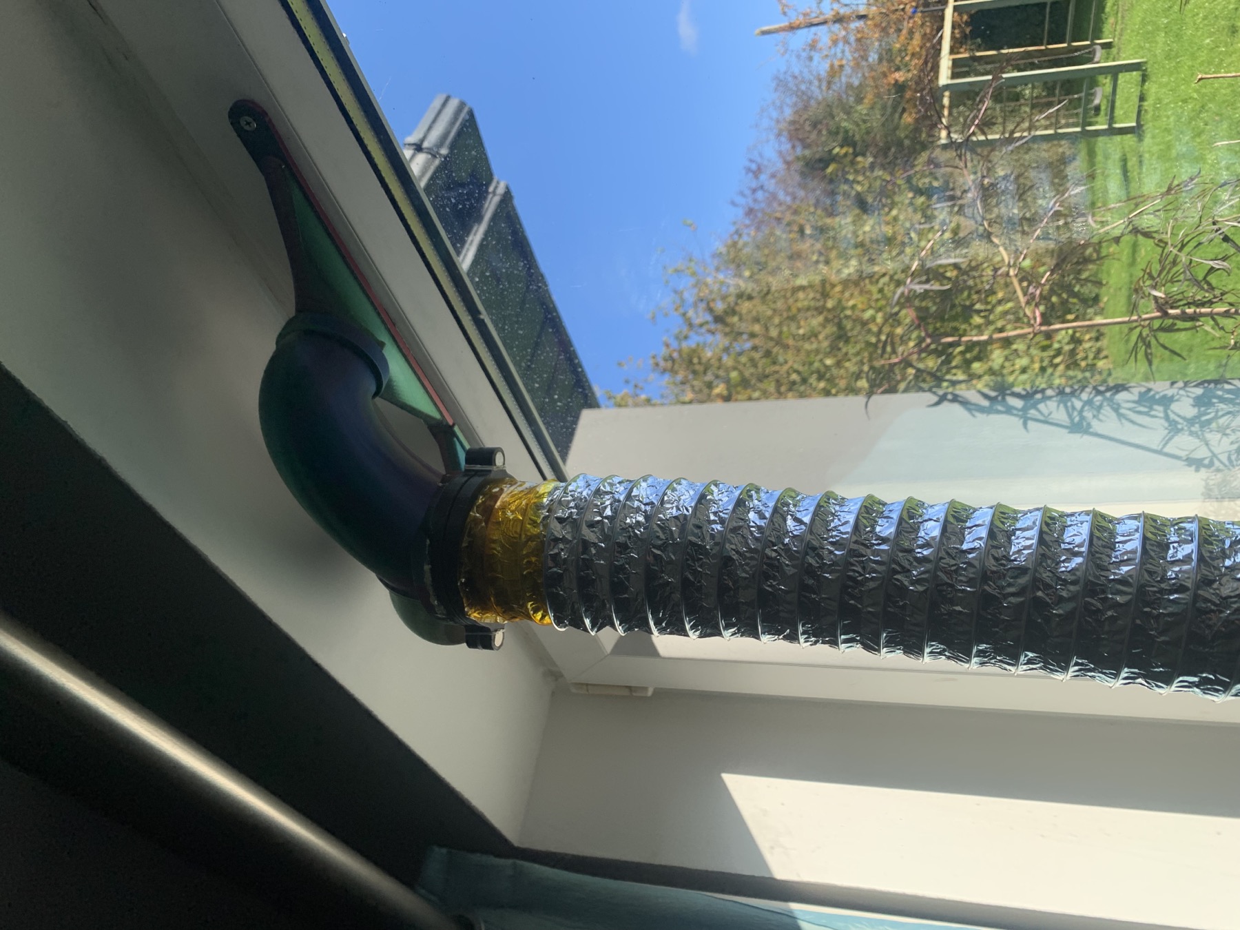Printed manifold fitted into the four trickle-vent slots and retained by the original cover screws