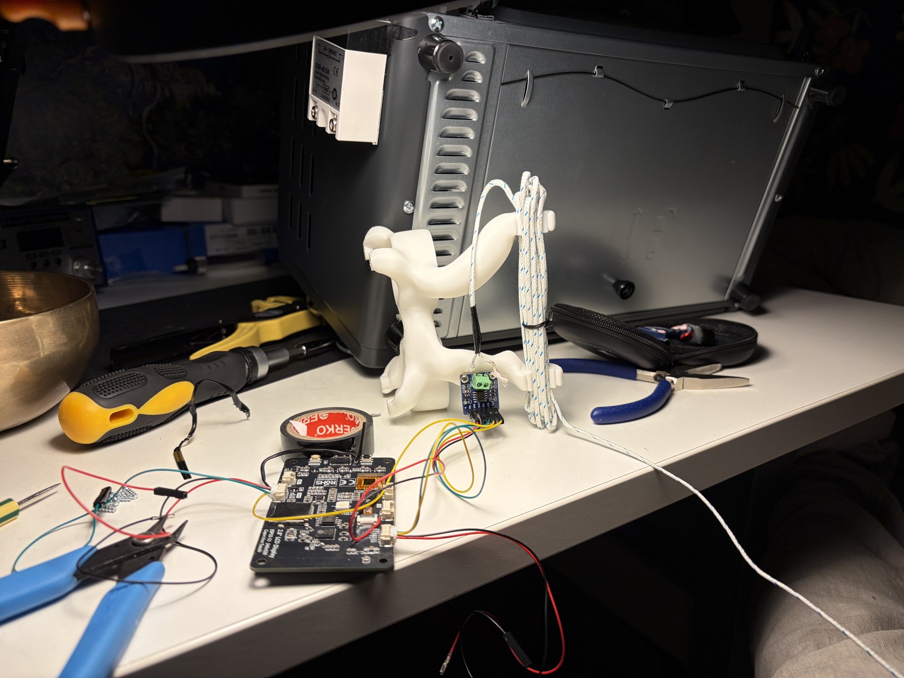 Controller board and wiring laid out beside the oven during assembly