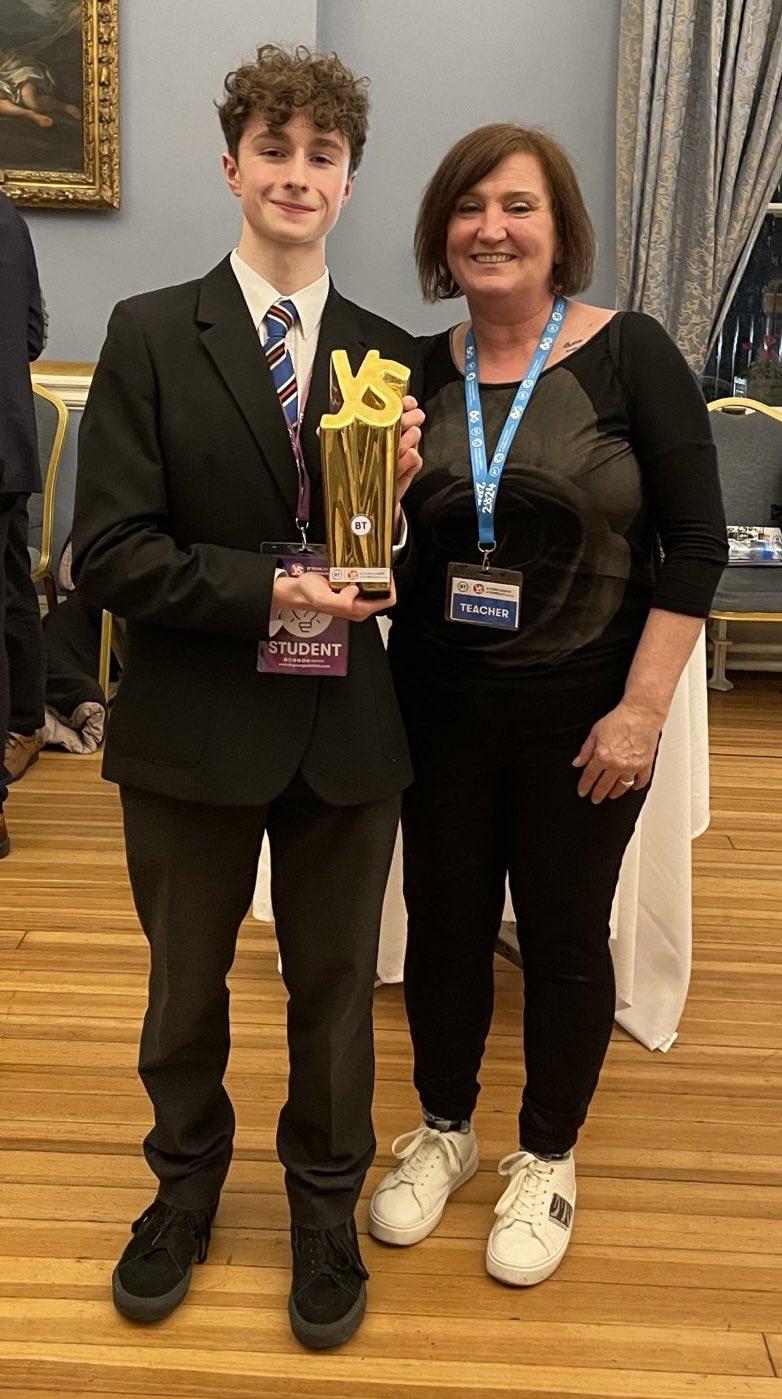 Seán holding the BT Young Scientist trophy beside his teacher