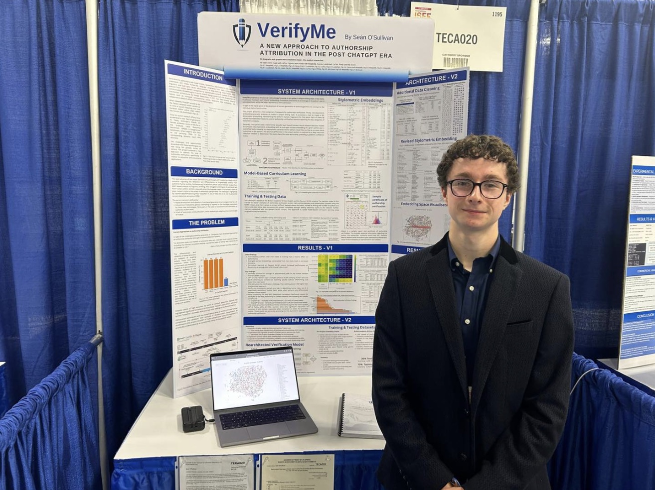 Seán standing beside his VerifyMe display at Regeneron ISEF 2025
